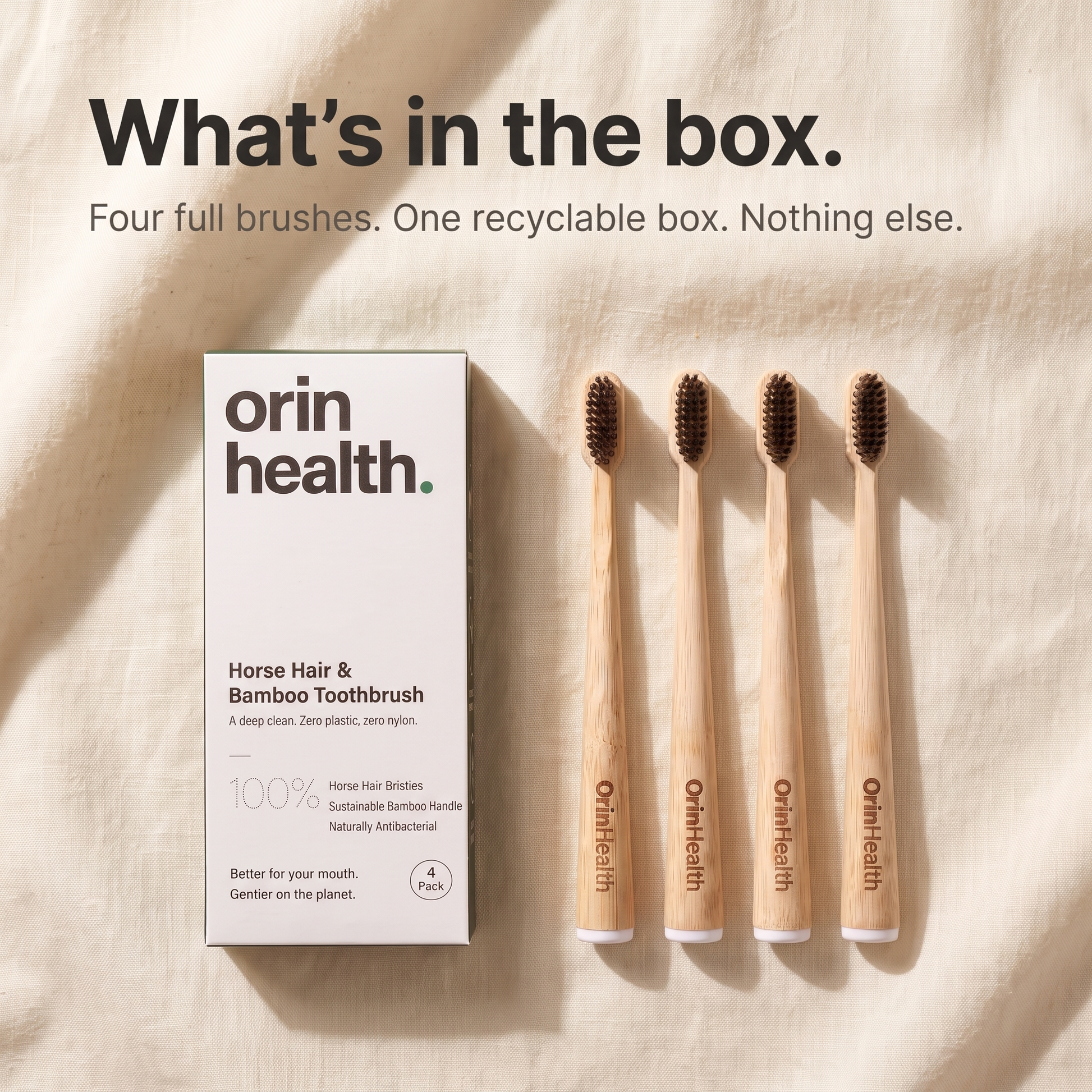 The OrinHealth Kindred box holding four bamboo toothbrushes